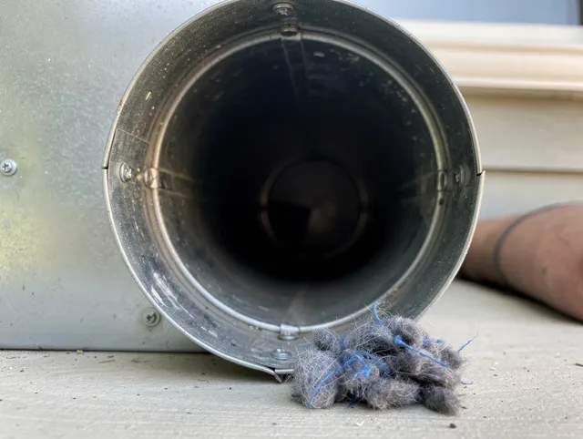 Canyon Lake Dryer Vent Cleaning technician using specialized equipment to clear severe dryer vent blockage in Canyon Lake